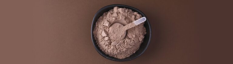 Foto, de cima, de um pote cheio de whey, com um medidor dentro -para que serve o Whey Protein Isolado